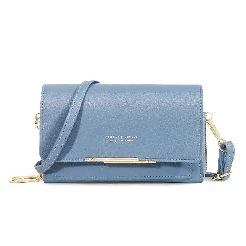 Sac à main CASSIE en cuir synthétique bleu, bandoulière ajustable, avec rabat, compartiments et poches pour organiser vos essentiels avec style et praticité.