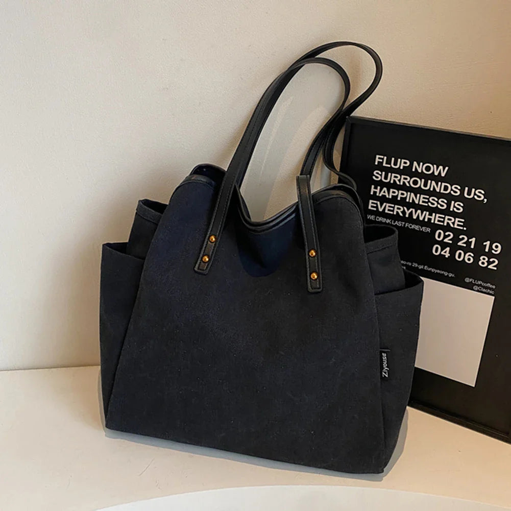 Grand sac cabas en tissu noir Selva, spacieux et pratique pour ordinateur, dossiers et effets personnels au quotidien.