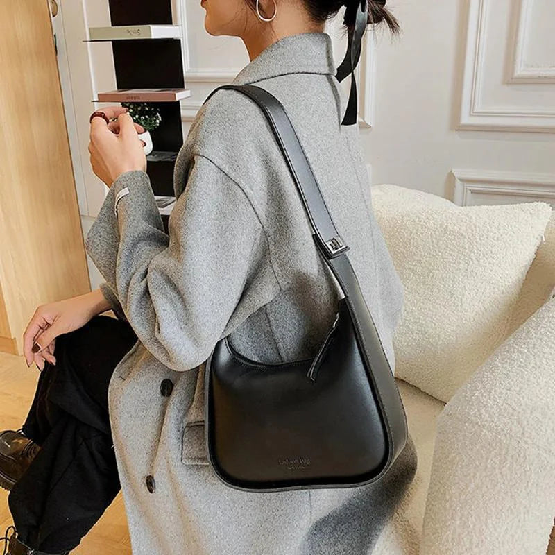SIRINA - Sac à main bandoulière en cuir souple noir élégant et pratique pour femme, porté en bandoulière