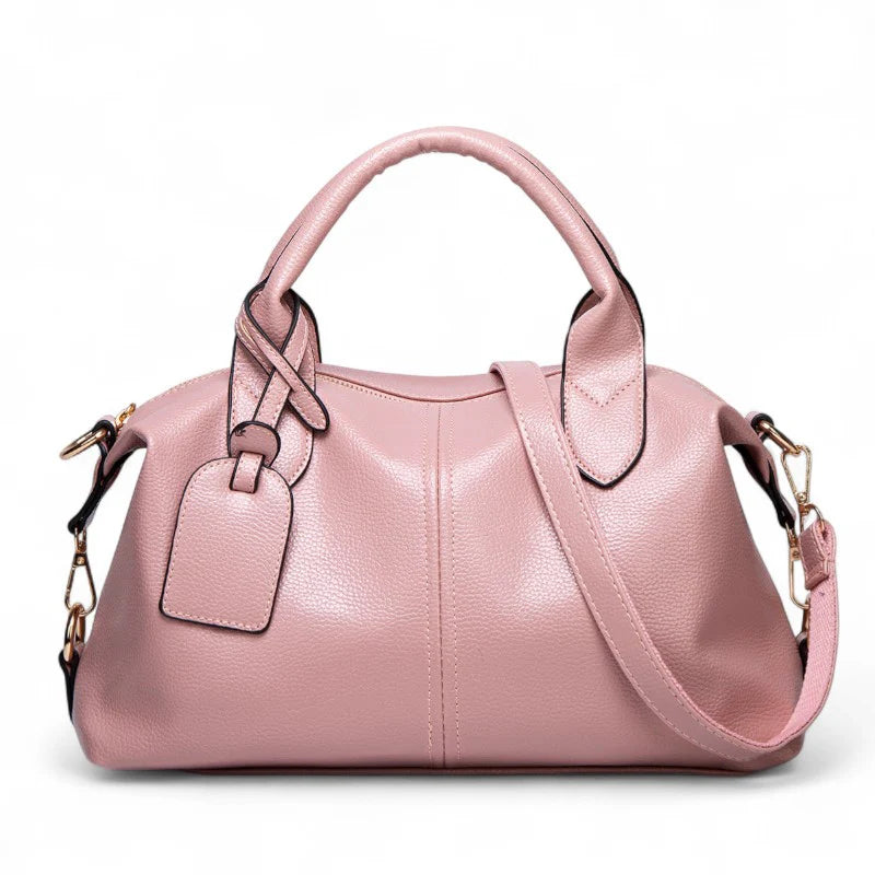 Sac à main bandoulière Yaelle en cuir rose texturé, élégant et pratique pour étudiantes et jeunes femmes, avec bandoulière ajustable, design chic et compartiments organisés pour transporter cahiers, ordinateur et accessoires du quotidien.